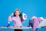 Premium Photo | Ironing clothes happy smiling girl shows thumbs up she likes to do household chores holds iron folds blouse