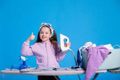 Premium Photo | Ironing clothes happy smiling girl shows thumbs up she likes to do household chores holds iron folds blouse