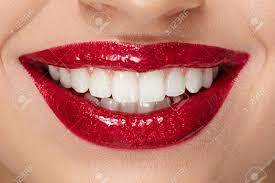 Smile With Red Lips And White Teeth. Close Up Of Smiling Woman's Mouth With Red Lipstick Makeup On Plump Full Sexy Lips And Healthy White Teeth. Beauty Anf Health. High Resolution. Фотография,